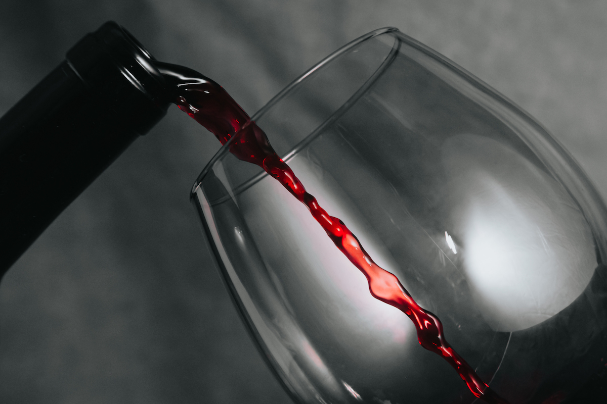 A bottle of wine serving wine in a cup with copy space in time stop with copy space Wine